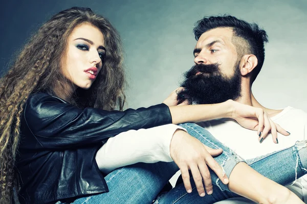 Young couple sitting on chairs — Stock Photo, Image