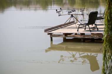 Wooden pier with fishing tackle