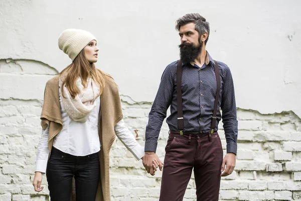 Young couple near wall