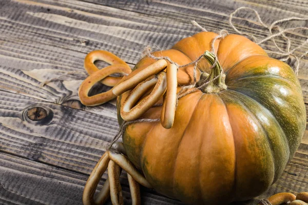 Pumpkin with bunches of cracknels — Stock Photo, Image