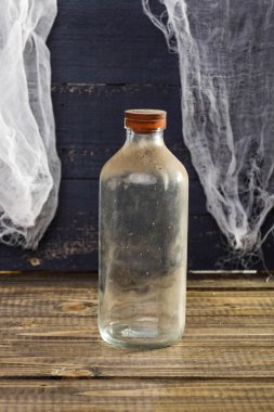 Still life dusty glass bottle
