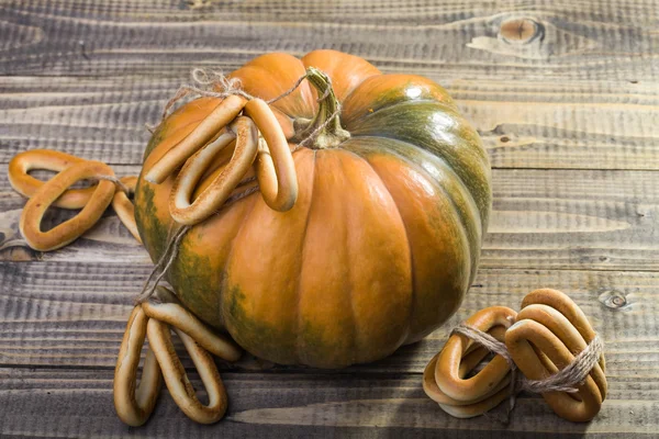 Pumpkin with bunches of cracknels — Stock Photo, Image