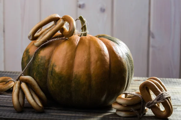 Pumpkin with bunches of cracknels — Stock Photo, Image
