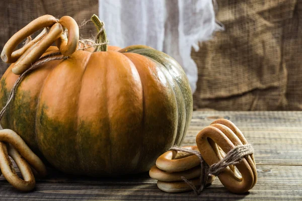 Pumpkin with bunches of cracknels — Stock Photo, Image