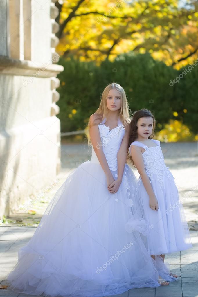 Two girls in white dresses 