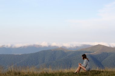 Woman with tea in mountains