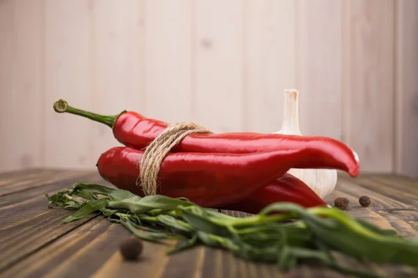 Red peppers and eating herb — Stock Photo, Image