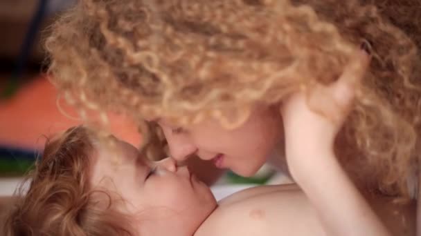 Happy childhood, young mother lovingly kisses the sleeping baby — Stock Video