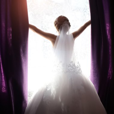 Bride in daylight window opening