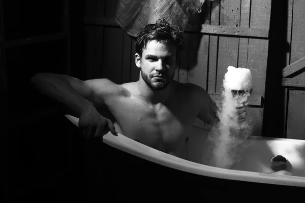 Man with glass in bath — Stock Photo, Image