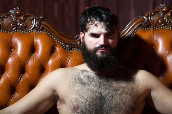 Bearded naked man on couch — Stock Photo, Image