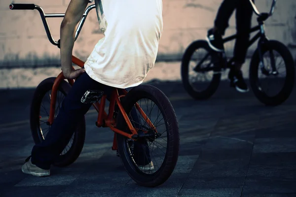 Twoo teenagers on bicycles