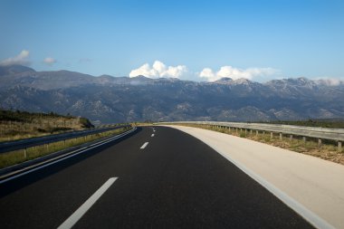 Modern asphalt highway in mountains clipart