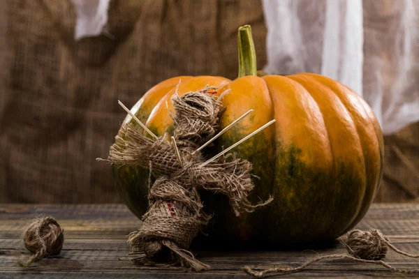 Rag voodoo doll near pumpkin — Stock Photo, Image