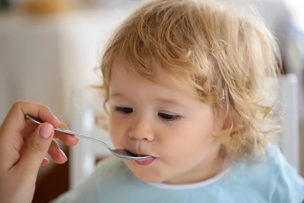 Baby boy fed with spoon — Stock Photo, Image