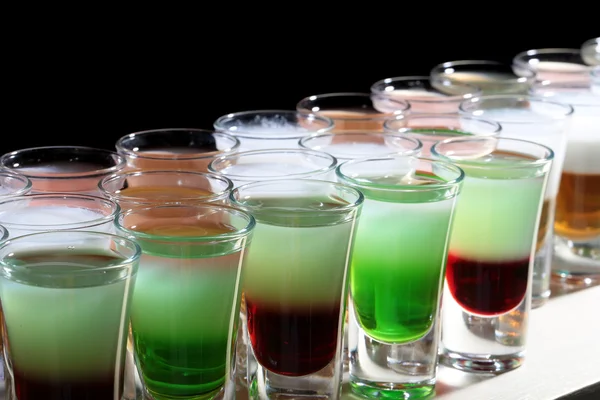 Line of many alcoholic shooters Stock Photo by ©Tverdohlib.com 98975992
