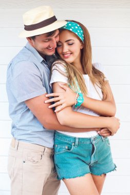 man and young pretty blonde hugs