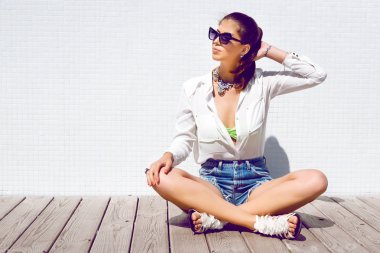 brunette woman posing on wooden floor