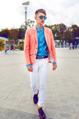 stylish man walking alone at the street