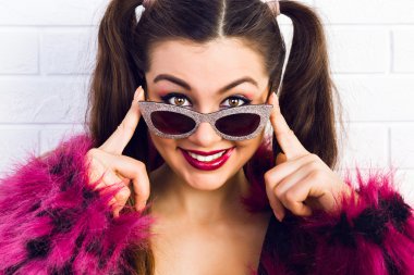 beautiful girl smiling and adjusting her glasses