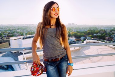 stylish girl posing at the roof clipart