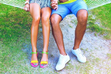 woman and man legs sitting at the beach