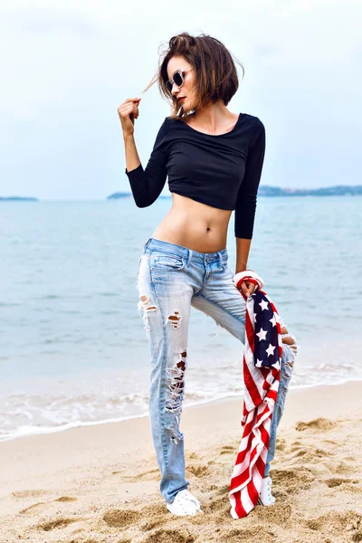 fit sexy woman holding american flag