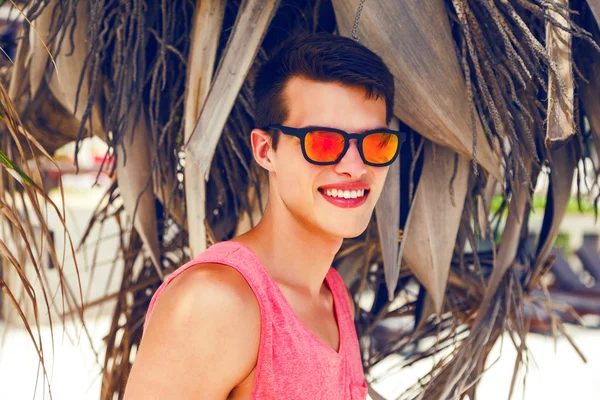 Handsome guy posing near palm tree — Stockfoto