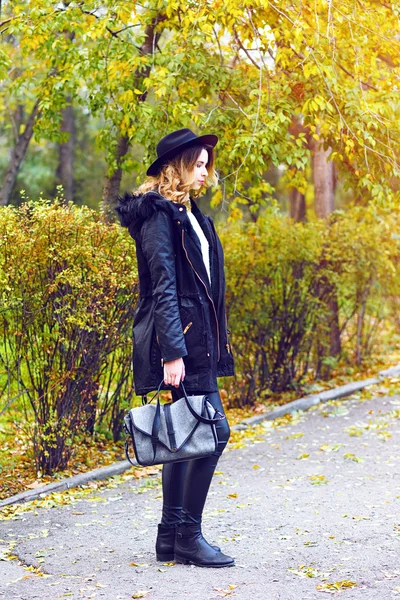 Woman walking at parka coat with bag — Stock Photo, Image