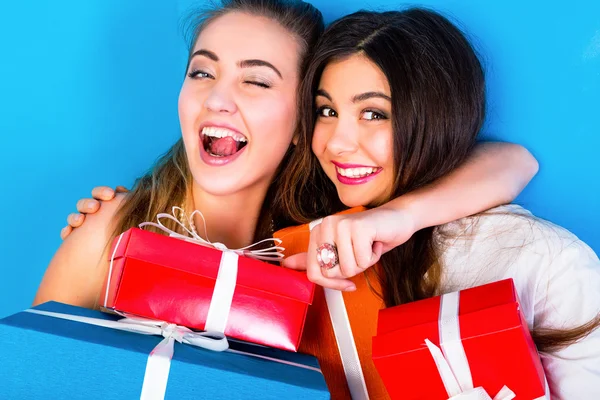 girls holding bright holiday presents