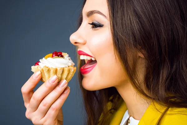 Brunette vrouw eten smakelijke taart — Stockfoto