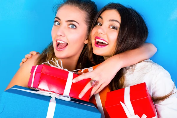 Girls holding bright holiday presents Stock Photo