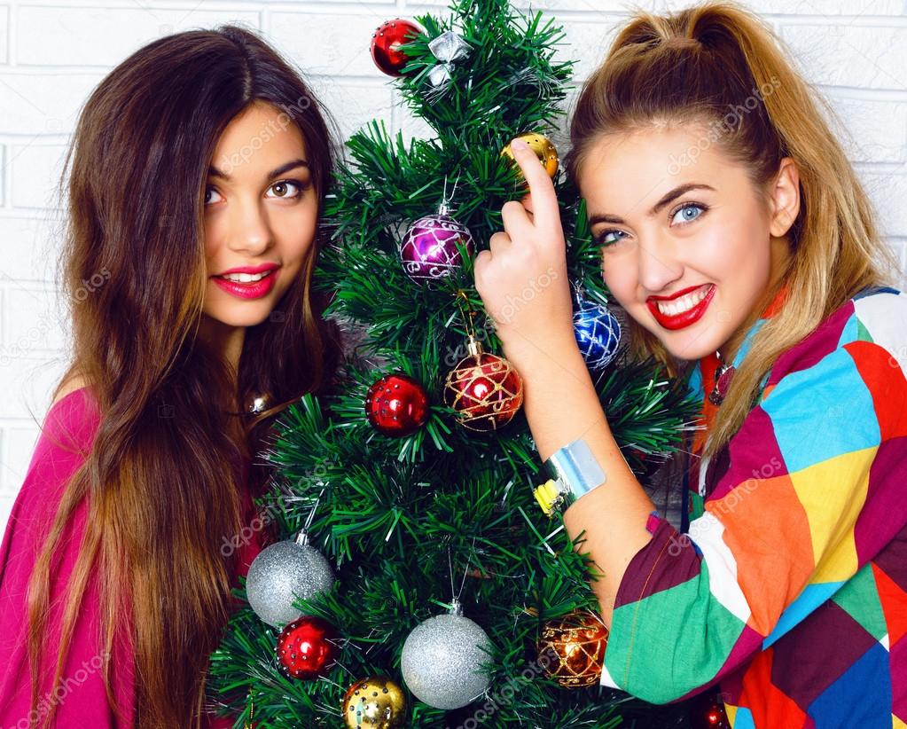 women posing near Christmas tree