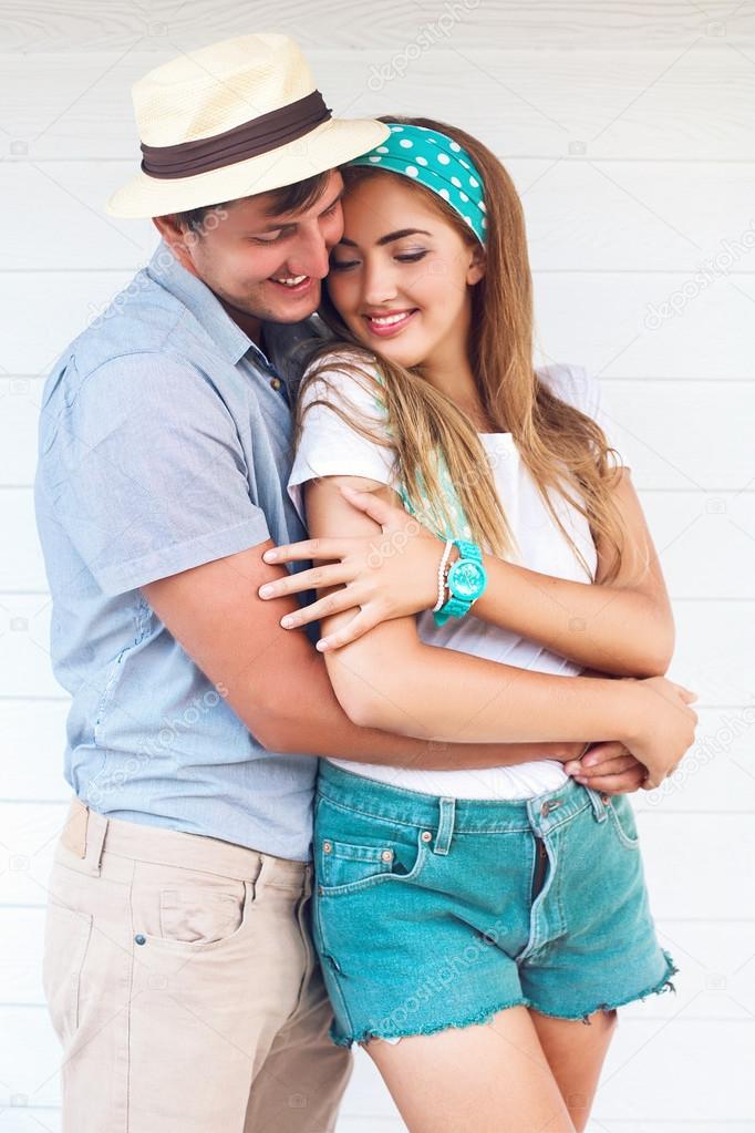 man and young pretty blonde hugs