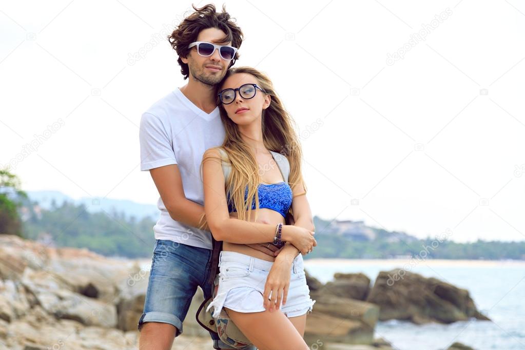 Young couple on the beach summer vacation. Happy man and woman look at the  sea 18043838 Stock Photo at Vecteezy