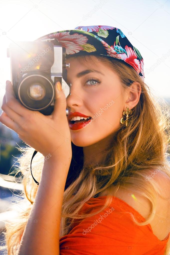 woman taking photo on retro camera
