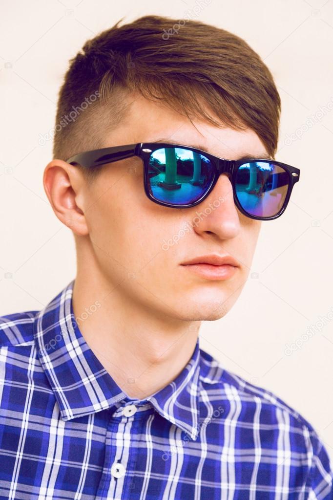 handsome stylish guy in mirrored sunglasses