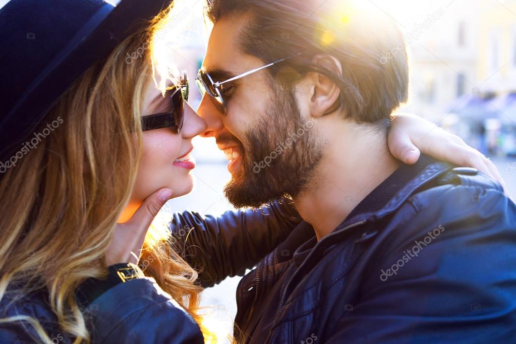 stylish sexy couple kissing on sunset