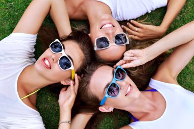 girls relaxed laying on the grass