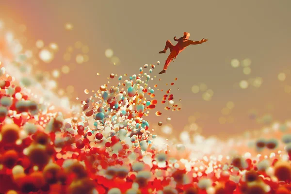 Homem pulando de muitas bolas coloridas — Fotografia de Stock
