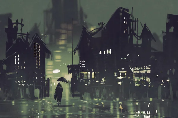 Человек с зонтиком гуляет по темному городу ночью — стоковое фото