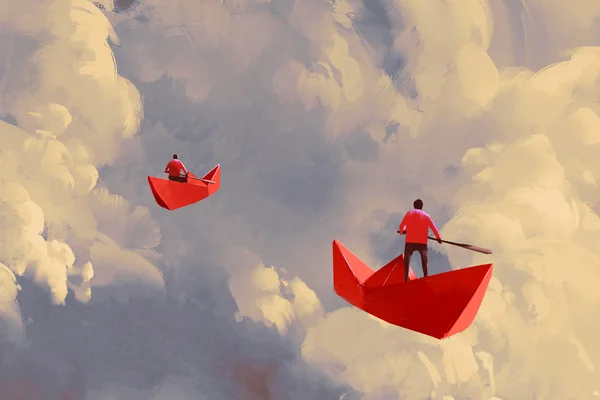 Hommes sur des bateaux en papier rouge flottant dans le ciel — Photo