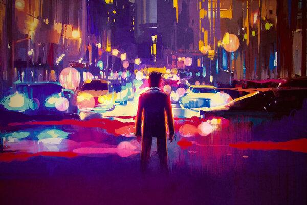 man standing on illuminated street at night