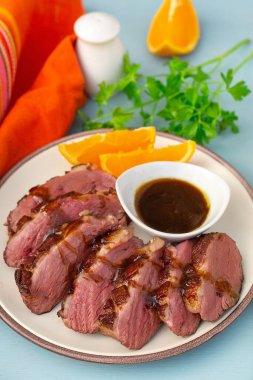 Rare fried crispy duck breast with orange sauce