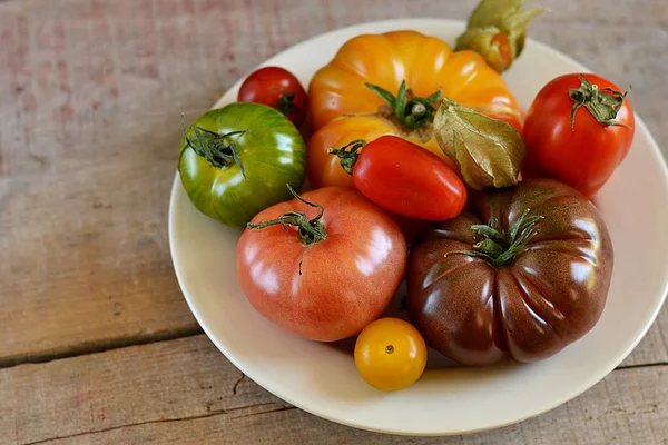 Verschillende soorten tomaten in een witte plaat — Stockfoto