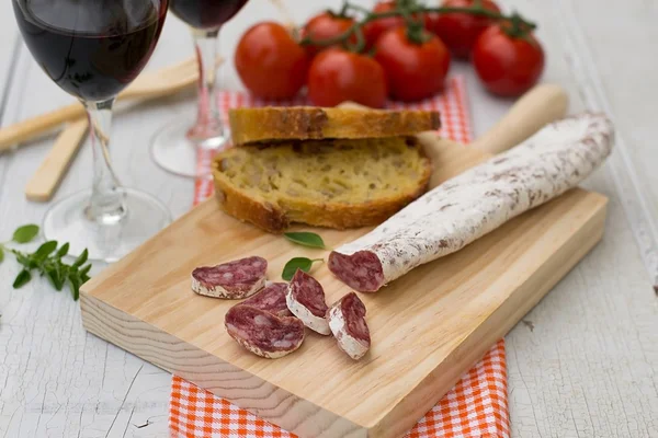 Dried sausage for tapas on the wooden board — Stock Photo, Image