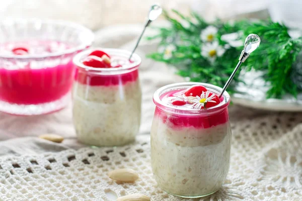 Rice pudding with almonds, whipped cream and cherry sauce — Stock Photo, Image
