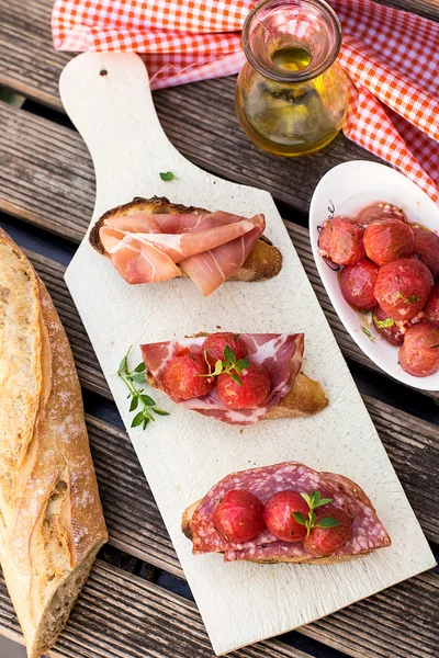 Italian bruschettas with ham prosciutto, coppa and salami — Stock Photo, Image