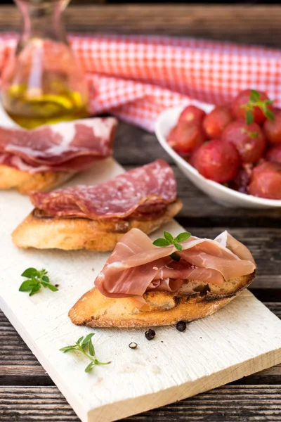 Italian ham dry cured prosciutto on bread toast — Stock Photo, Image