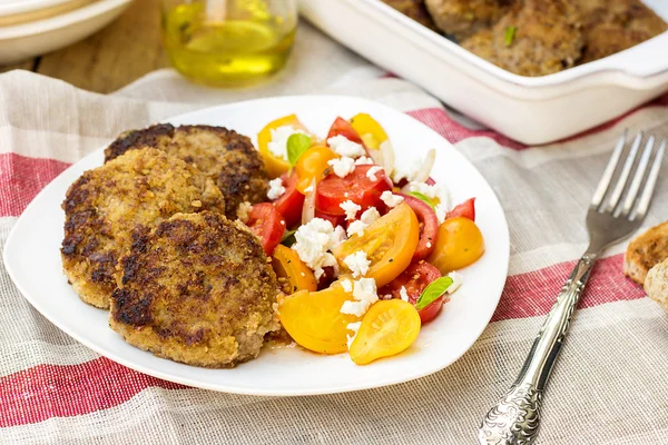 Boulettes de viande avec courgette courgette servie avec salade de tomates — Photo